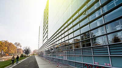 A modern glass and steel building in the afternoon sun.