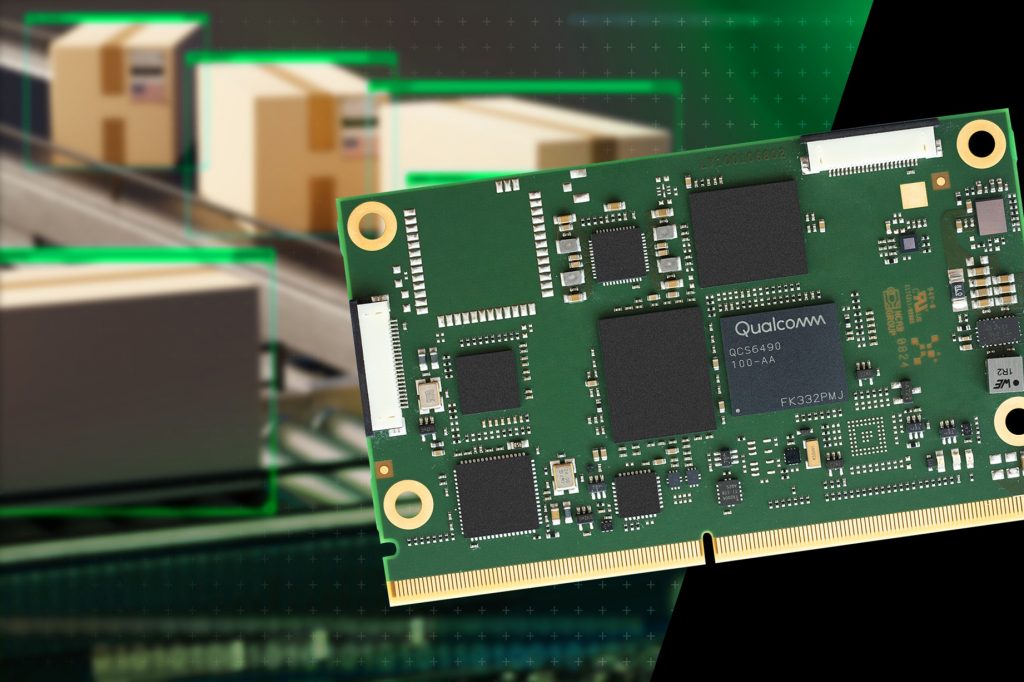 Close-up of a green compute board next to a conveyor belt with brown cardboard boxes on it. There is a Qualcomm logo printed on the board.